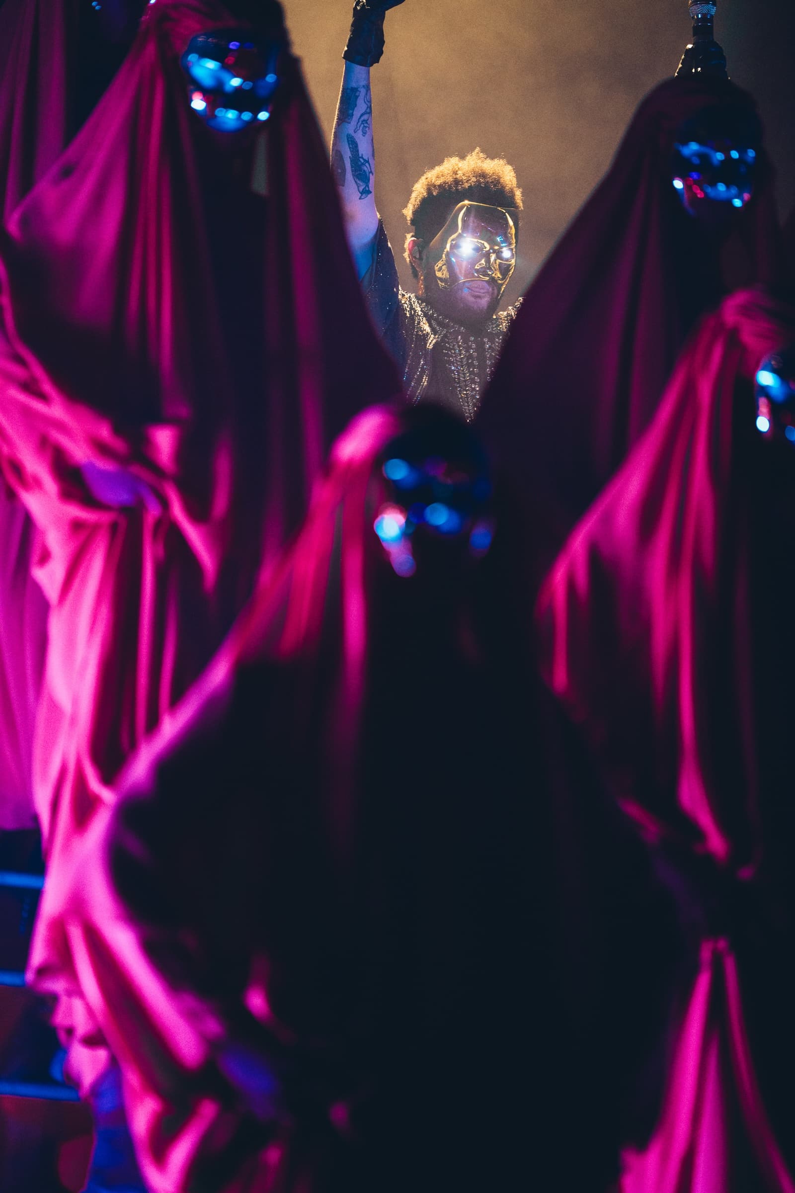 Live concert performance with dramatic lighting