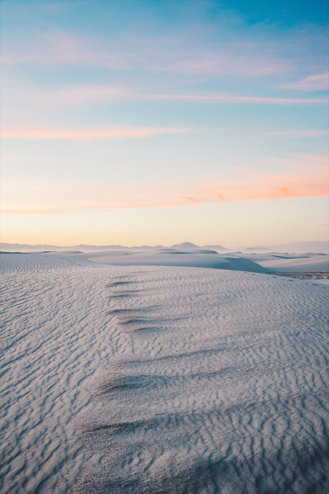 White Sands dunes stretching to the horizon under bright sky