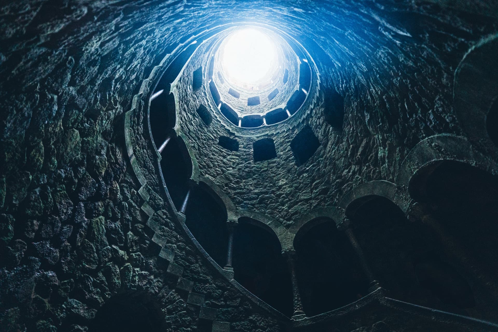 Sintra Initiation Well spiraling staircase with golden light