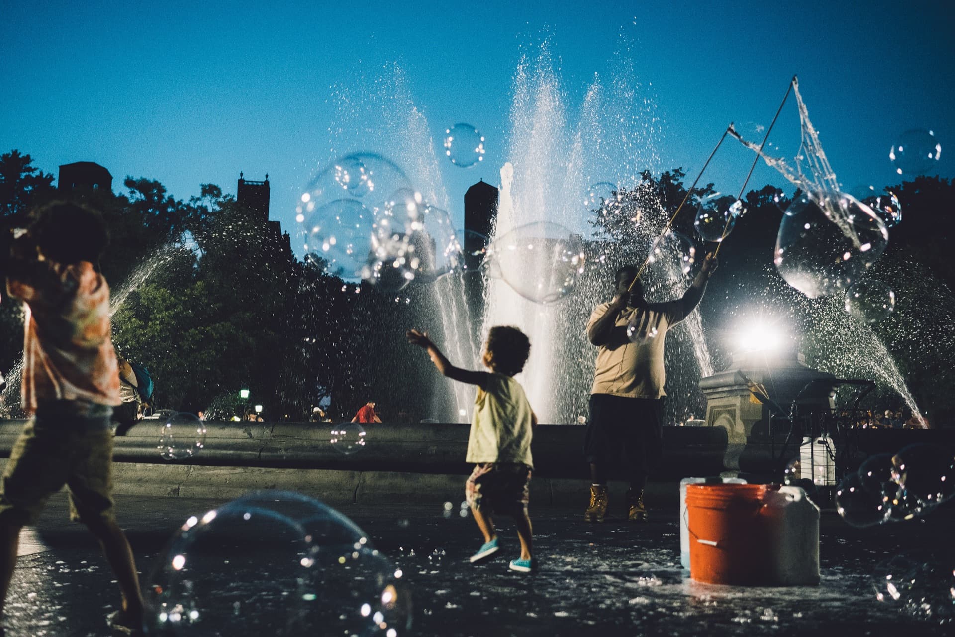 Bubbles floating in Central Park sunlight
