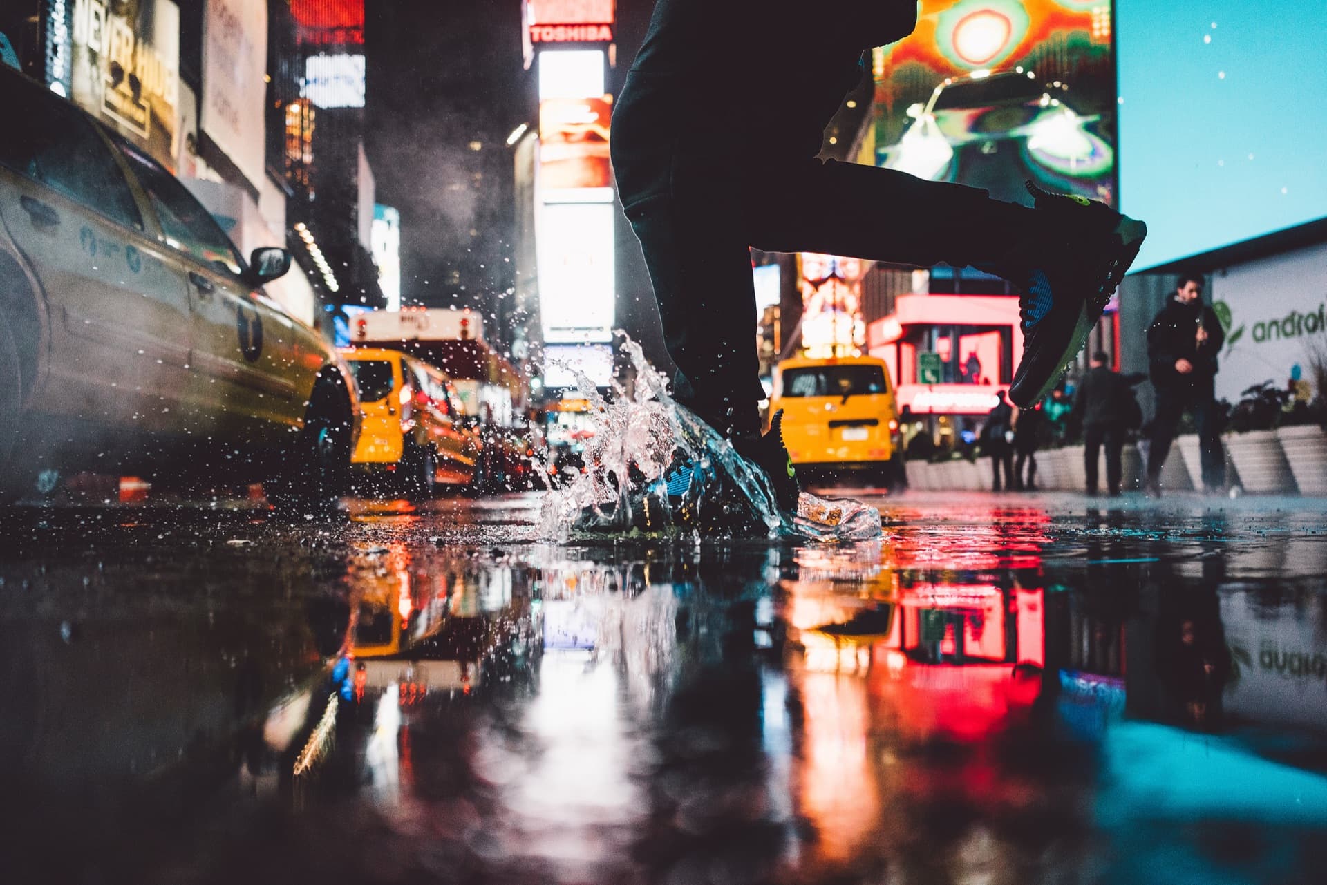 NYC skyline reflected in street puddle