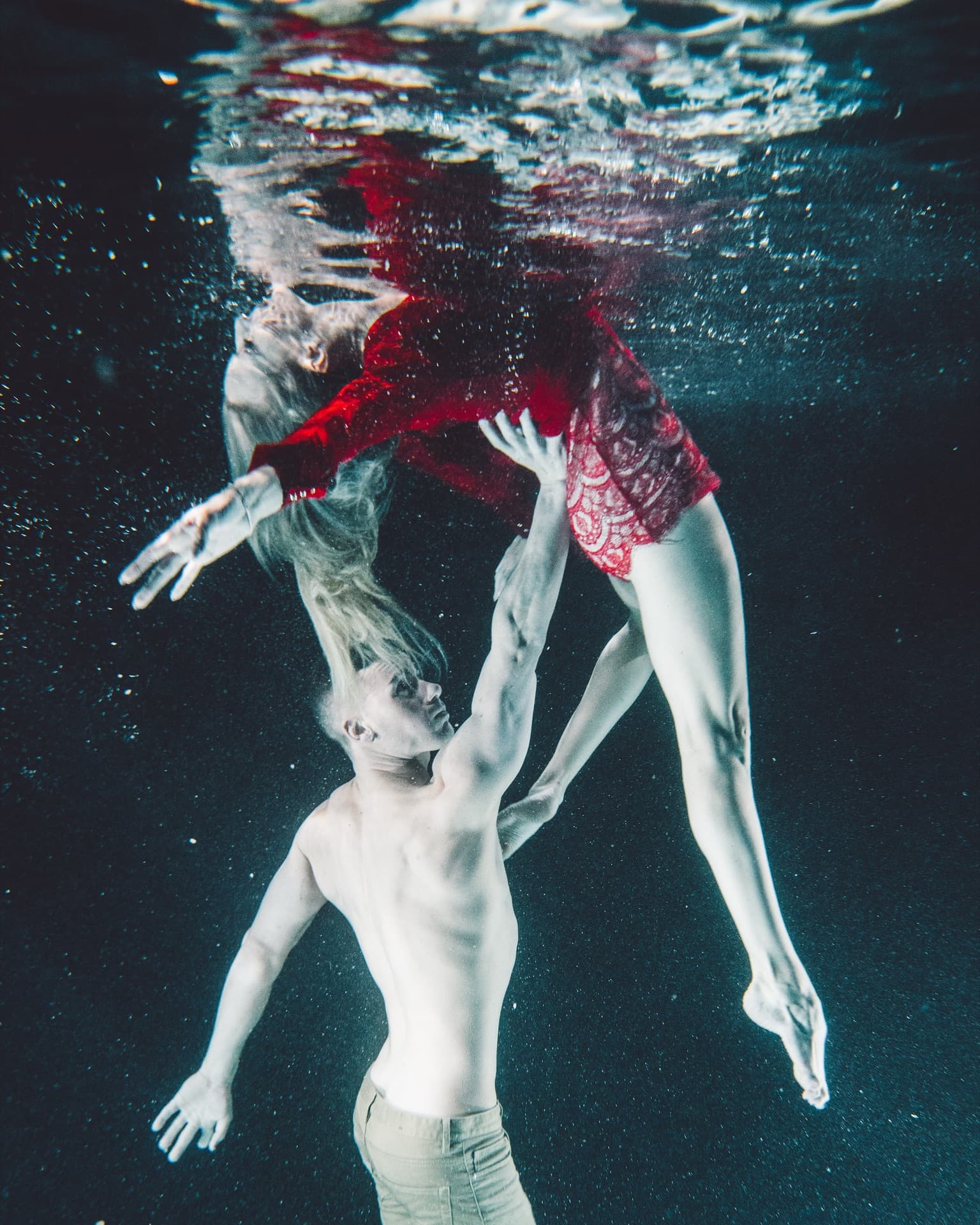 Underwater portrait of couple swimming together